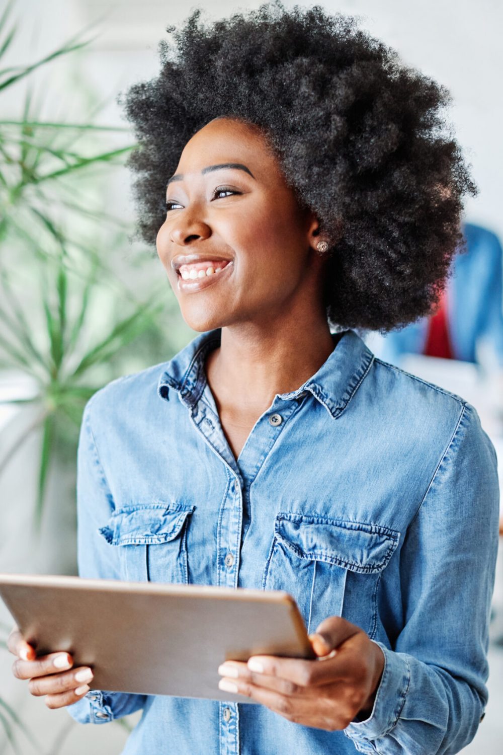 portrait of a smiling young businesswoman holding a tablet in the office